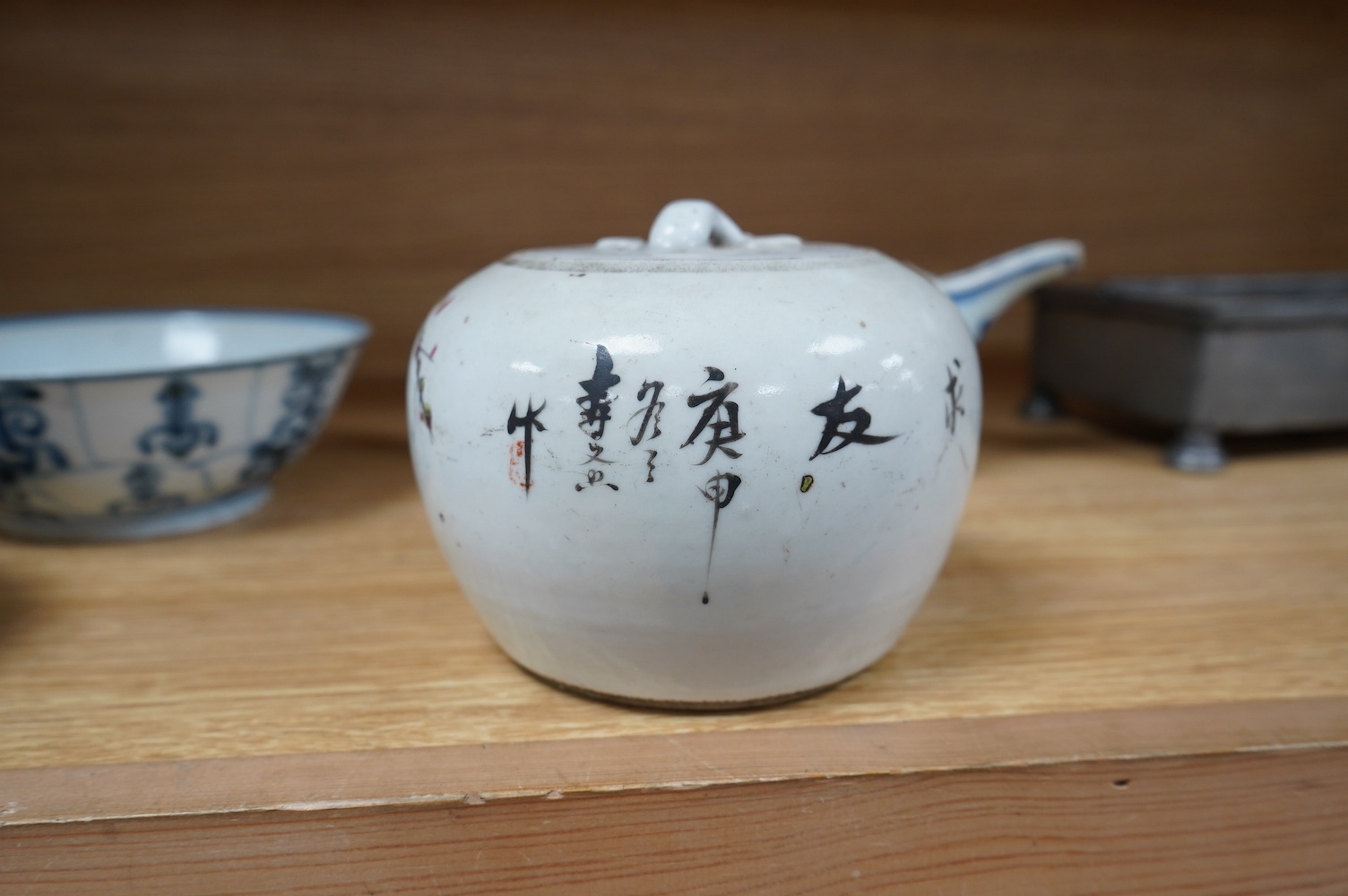 Three pieces of Chinese blue and white porcelain, including a double lipped sauceboat, 8.5cm high, and a famille rose lidded pot. Condition - fair